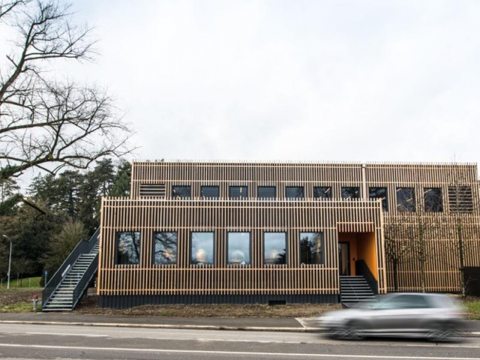 Two-story employee restaurant with sustainable wood facade cladding.