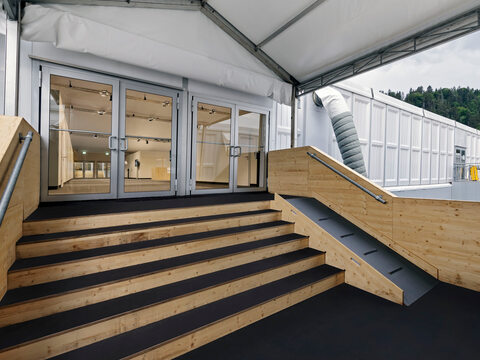 The system material clad in wood was also used for access points and connecting platforms between the tents.